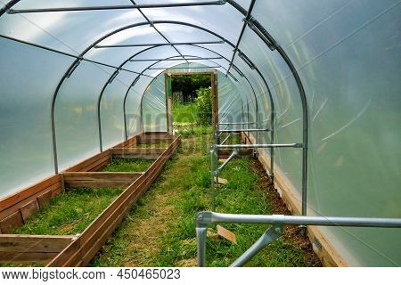 Polytunnel Under Construction - Staging Supports Connected Polytonal Hoops And Vegetable Beds Being 