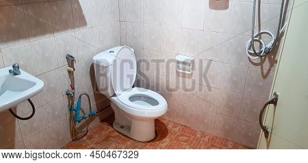 Bathroom, Toilet, Water Closet, Restroom Or Washroom With White Basin, Wash Basin, Washboard, Flush 