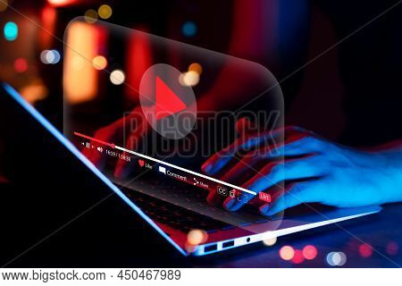 Online Movie Streaming With Laptop Computer, Young Man Watching A Movie On A Mobile Phone With An Im