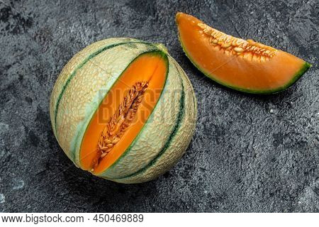 Cantaloupe Melon. Whole And Slice Of Japanese Melons, Orange Melon With Seeds On Dark Background. Pl