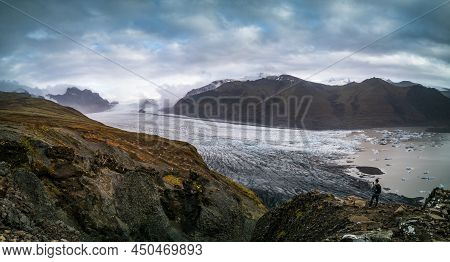 Tourist On Top Of Spectacular Viewpoint To Glacier