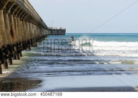 Tolaga Bay New Zealand - February 5 2022; Surfer Riding Waves By Tolaga Bay Wharf