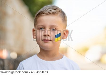 Child Against War. Hopefull Ukrainian Boy With Bue Yellow Flag On His Face Protesting War Conflict. 