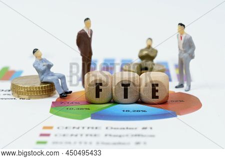 Business And Finance Concept. On Financial Reports With Diagrams, Figures Of Businessmen And Wooden 