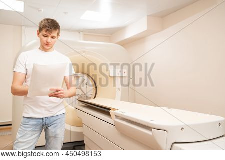 Engineer Fills After Maintenance Documents. Computer Tomograph.