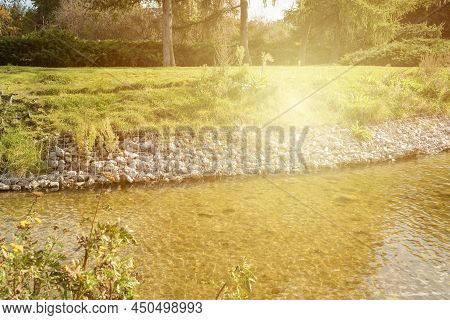 Strengthening The Banks Of The River, Mesh And Stones. Landscape River Bank And Large Stones With Me