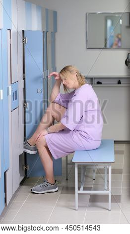 Woman Touching Her Forehead Getting Tired After Running Or Workout. Pretty Woman Sitting On A Bench 
