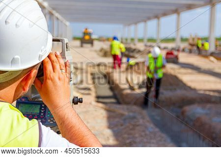 Surveyor Engineer Is Measuring Level On Construction Site. Surveyors Ensure Precise Measurements Bef