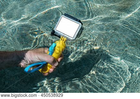 Mockup Action Camera In The Hand Of A Guy Submerged In The Water Of The Pool.
