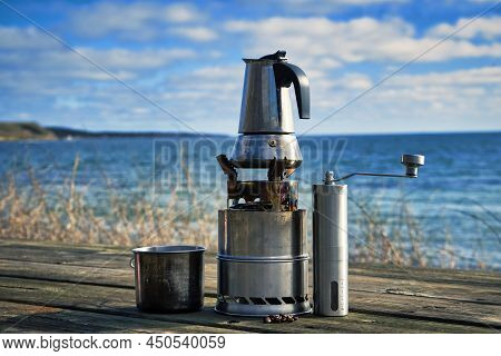 Cup Of Coffee Moka Pot On A Table Over Blue Sky And Sea, Ready To Drink