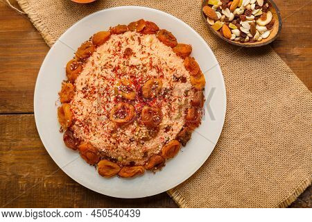Masfouf From Couscous On Almond Milk With Dried Fruits And Nuts On A Wooden Table Next To Nuts And R