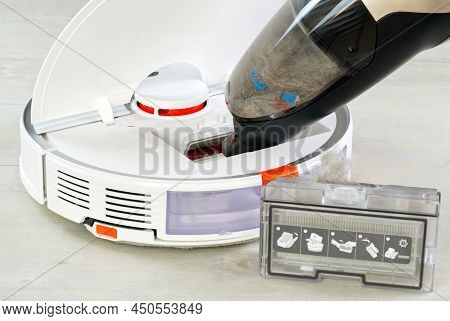 Robot Vacuum Cleaner Cleaning With Other Hoover. The Filter Lid Is Opened To Clean. Smart Cleaning A