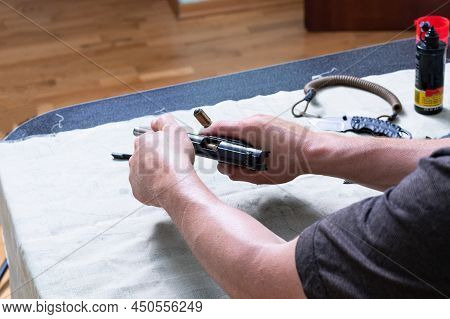 Reloading A Pistol. The Flight Of A Bullet From A Pistol Clip. Pistol In Hand. The Bullet Is Fired F