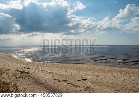 Carnikava, Latvia, Coastal Scene At The Baltic Sea With Fallen Trees In A Sunny Day