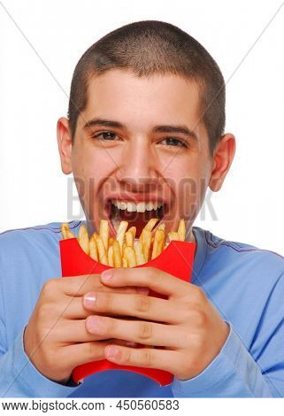 Funny kid biting frensh potato fries bag portrait on white background.