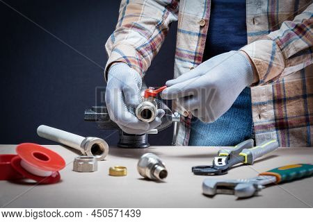 The Man Is Installing Or Repairing The Water System In The House. Plumbing Repair Service. Diy Conce