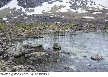 View Of The Area Near The Lake Blavatnet, Rocks And Water, Lyngen Alps, Norway