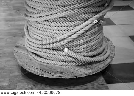 A Drum With A Coiled, Wound Rope, A Rope.