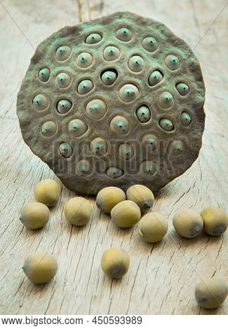 Fresh Green Lotus Seed Pods And Lotus Seeds Green On Old Wooden Board Background. Selective Focus.