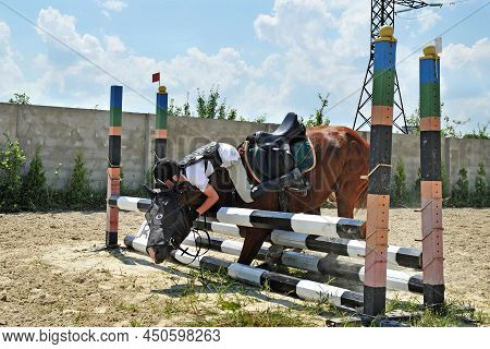 Falling Rider With A Horse While Overcoming A Barrier