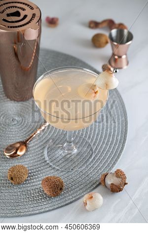Pink Lychee Cocktail. Champagne Coupe Glass Filled With Pink Lychee Cocktail Or Mocktails Surrounded