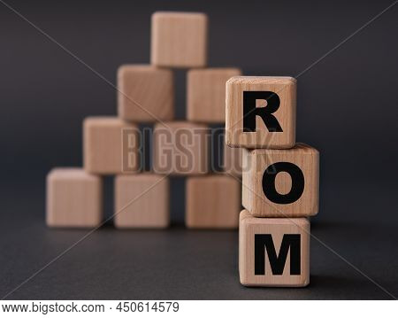 Rom (read Only Memory) - Acronym On Wooden Cubes On A Dark Background. Business Concept