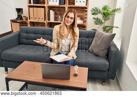 Young blonde woman psychologist having teleconsultation at psychology center