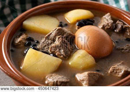 Traditional Jewish Cholent In Bowl On Wooden Table. Close Up