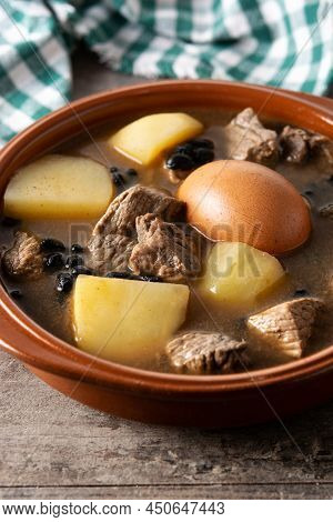 Traditional Jewish Cholent In Bowl On Wooden Table. Close Up