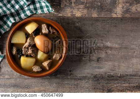 Traditional Jewish Cholent In Bowl On Wooden Table. Top View. Copy Space