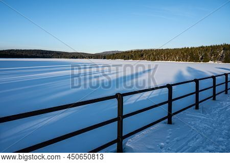 Cerna Nisa, Or Bedrichov, Dam In Sunny Winter Evening. Snowy Landscape Wing Long Sunset Time Shadows