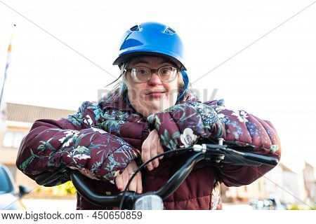 Outdoor Portrait Of A 39 Year Old White Woman With The Down Syndrome Resting On The Steering Wheel O