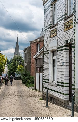 Uccle, Brussels - Belgium - 06 14 2019 - Young Couple Walking The Curling Saint Job Street With A Vi