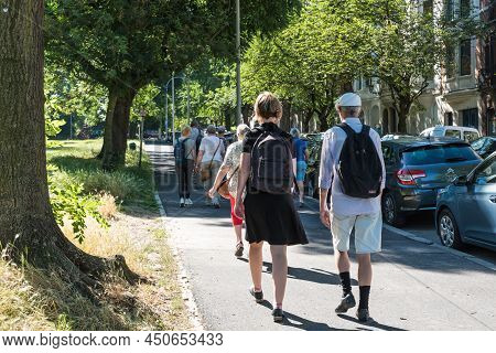 Schaerbeek, Brussels, Belgium - 06 29 2019, Group Of Local Tourists Walking In A Green Park
