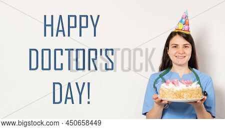 A Woman Holds A Birthday Cake, A Banner With Text Happy Doctors Day