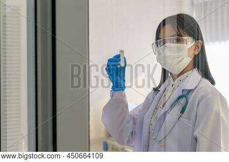 Young Female Doctor Holding Atk Kit In Hospital, Covid19 And Pandemic Concept