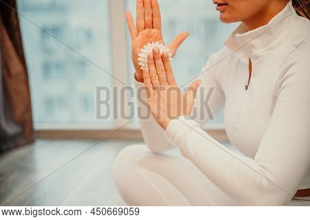 Athletic Slim Caucasian Woman Doing Thigh Self-massage With A Massage Ball Indoors. Self-isolating M