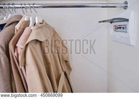 Automatic Fusein A Home Electrical Panel In The Closet With Clothes. Electricity Equipment In The Ap