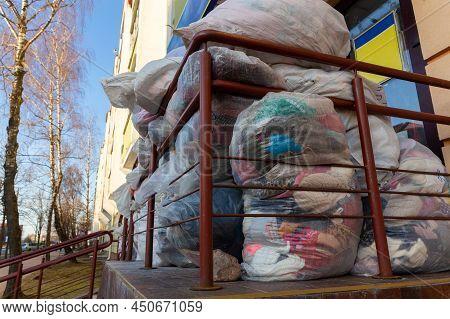 Used Clothes And Shoes In Plastic Bags. New Arrival Of The Goods In The Second-hand Store. Humanitar