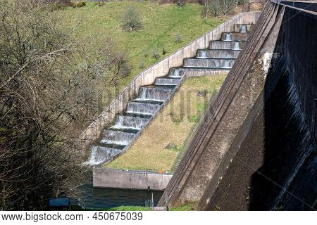 Long Exposure Of The Waterfalls Flowing Over Wimbleball Dam In Somerset