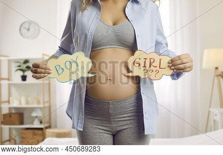 Future Mother Holding Two Cards And Thinking About The Gender Of Her Unborn Baby