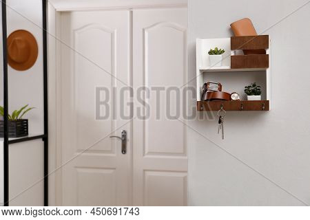 Hallway Interior With Stylish Accessories And Wooden Hanger For Keys On White Wall