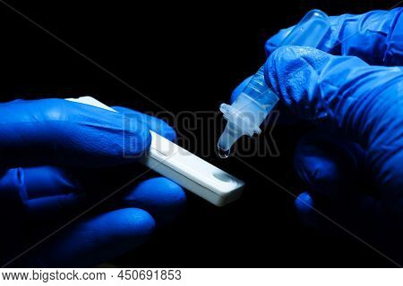 Medical Personnel Hand Placing The Secretions Sample Into The Sars Cov-2 Rapid Antigen Test Kit (atk