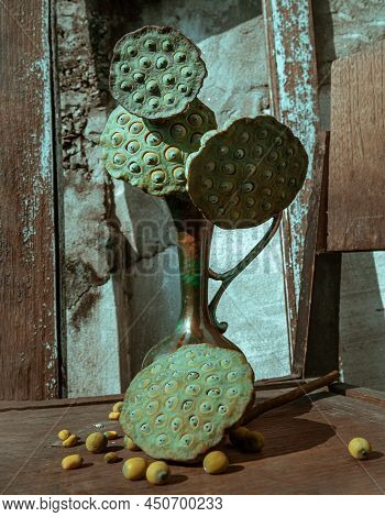 Fresh Green Lotus Seed Pods In Antique Carved Iron Jug Or Vase On Old Wooden Chair. Selective Focus.