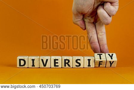 Diversity Or Diversify Symbol. Businessman Turns Wooden Cubes And Changes The Word 'diversify' To 'd