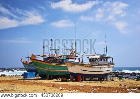 Dondra Port, Sri Lanka. Abandoned Fishing Boats On The Shore. Dirty Harbor And Old Ships.
