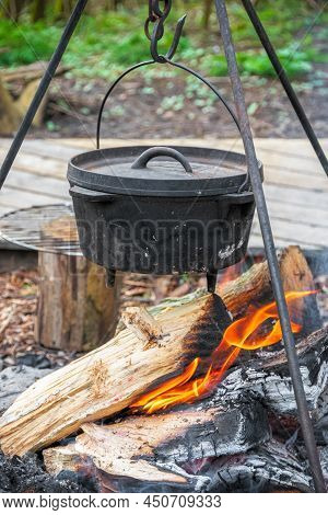 Cooking Food In A Cauldron Over Campfire In England