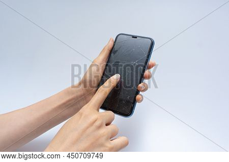 Smartphone With Badly Damaged Screen On A White Background