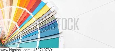 Color Guide Close Up. Assortment Of Colors For Design. Colors Palette Fan On A White Concrete Wall B