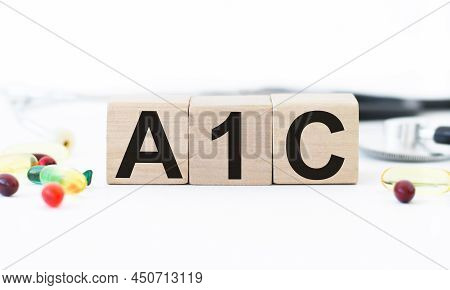 Wooden Cubes With The Inscription A1c Diabetes Diagnosis, On White Paper On Gray Background Medical 